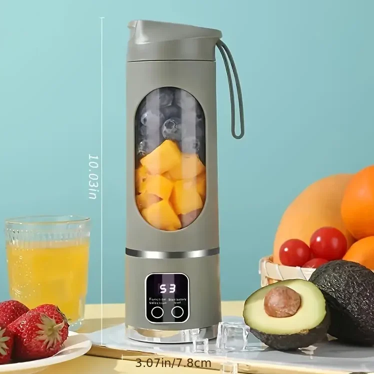 Portable blender with cut fruits, juice, and various whole fruits on a table.